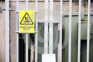 Danger of death keep out yellow sign on power substation fence