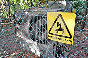 Danger of death sign on fence of electricity sub-station compound