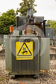 Danger of Death warning triangle with Electricity symbol on transformers at substation.