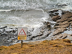 Danger deep drop sign by Atlantic ocean, Rosses point, county Sligo, Ireland