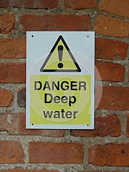 Danger Deep water sign on a brick wall