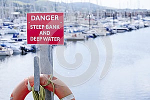 Danger deep water and steep bank at sea harbour marina