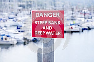 Danger deep water and steep bank at sea harbour marina