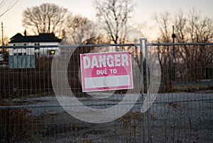 Danger due to construction sign on fence