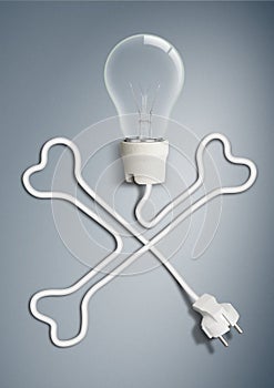 Danger electricity concept, light bulb with cable as bone skull