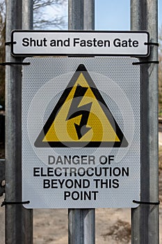 Danger of electrocution sign on a railway access gate