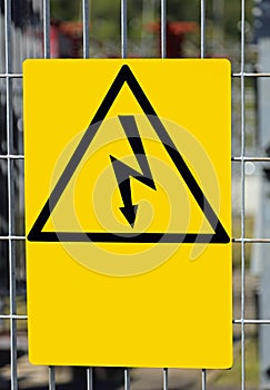 Danger high voltage risk of death sign  with lightning bolt in yellow triangle photo