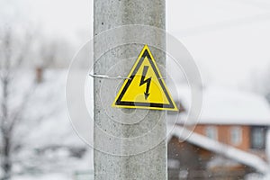 Danger high voltage warning sign on electric pole