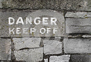 Danger keep off sign on stone