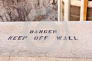 Danger, keep off wall