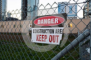 `Danger, keep out, construction area` sign on the fence.