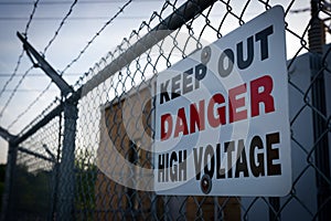 Danger Keep Out High Voltage Sign on Barbed Wire Fence