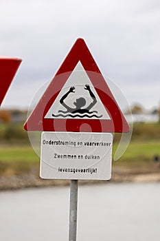 Danger for life sign next to a river and port entrance
