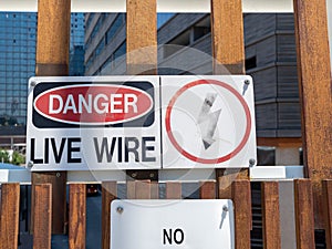 Danger live wire power lightning bolt warning sign posted near hazard