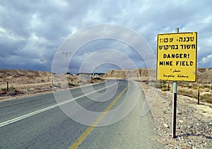 `Danger! Mine field` sign in English, Hebrew and Arabic languages