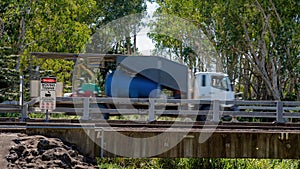 Danger Moving Trains Sign With Blurred Motion Traveling Truck