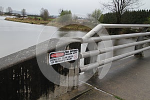 A danger no diving sign on a concrete wall