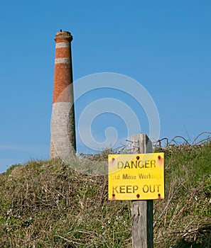 Danger old mine workings sign with cornish mine works chimney