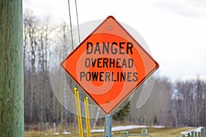 Danger overhead powerline sign beside a power pole