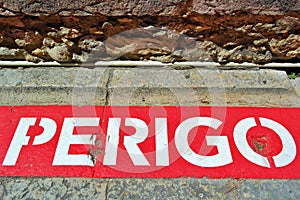Danger, Perigo sign, red and white sign, stone background photo