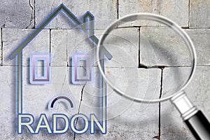 The danger of radon gas in our homes - concept image with an outline of a small house with radon text against a cracked stone wall