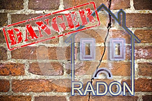 The danger of radon gas in our homes - concept with a small house with danger radon text against a cracked brick wall