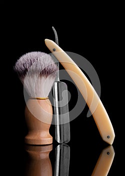 Danger razor and shaving brush on a black background