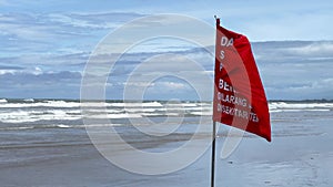 Danger. Red flag warning of the dangers of swimming in the Indian Ocean on the shores of the island of Bali, Indonesia