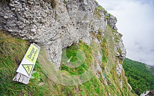 Danger risk of falling sign on mountain