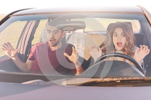Danger on road. Mad young woman and man have car crash, looks in terror in windscreen. Depressed female can`t control movement and