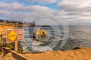 Danger Sign with Bird Rock at Sunset Cliffs