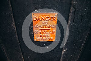 Danger sign on a black door