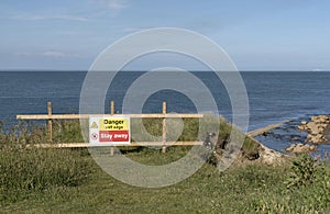 Danger sign on a cliff edge