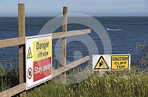 Danger sign on a cliff edge