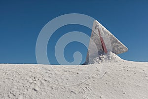 Danger sign, covered with snow, on the Sunny day, on top of Rose Peak mountain