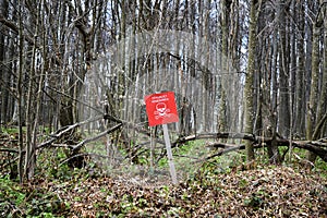 Danger sign in front of minefield - translation from Croatian: Danger mines