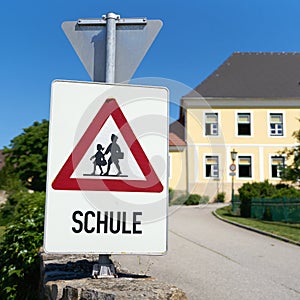 Danger sign indicating possible school children in the road area