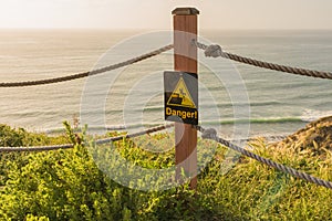 Danger Sign on an Ocean Side Cliff