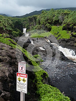 Danger sign at Oheo park in Maui, waterfalls