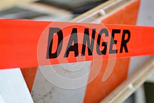 Danger sign on red tape