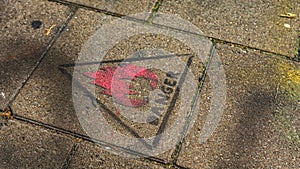 ` Danger ` sign stamped on the pavement in Ghent, Belgium