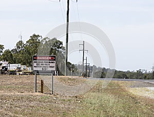 Danger sign warning of high voltage power lines photo