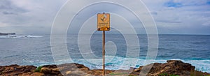Danger signage at coastal cliff-edge