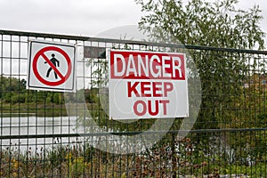 Danger signs on the fence outdoors