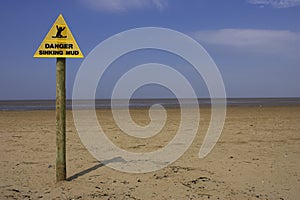 Danger sinking mud sign, sand point beach England uk
