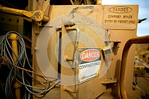 Danger tag confined space sign entry  authorised personnel by permit only with gas test detector atmosphere hanging on the door