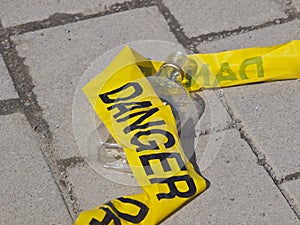 Danger Tape and Alcohol Bottle