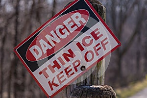 Danger thin ice sign on post