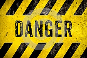 DANGER warning sign word text yellow black stripes concrete wall cement texture background. Danger dangerous warning