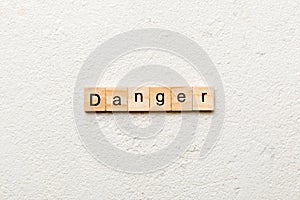 Danger word written on wood block. Danger text on cement table for your desing, Top view concept